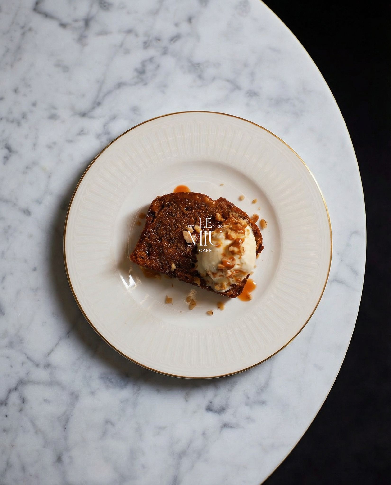 Sticky toffee cake on fine porcelain, marble table